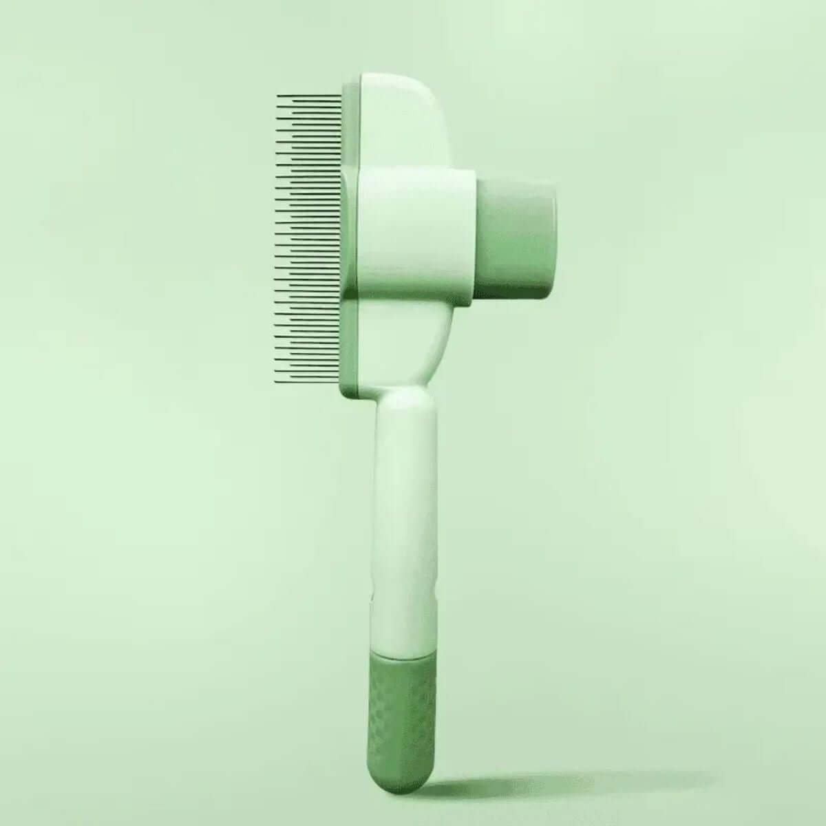 One-click pet grooming brush in green color, designed for gentle hair removal for dogs and cats.