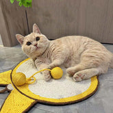 Cute cat lounging on a sisal cat scratching mat with a playful yellow ball, showcasing the durable design and natural materials.