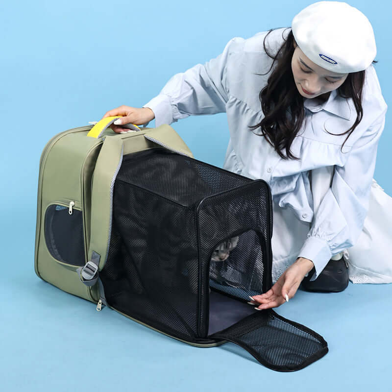 Woman using a portable carrier bag for cats, showcasing a cat carrier travel backpack in gray.
