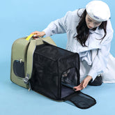Woman using a portable carrier bag for cats, showcasing a cat carrier travel backpack in gray.