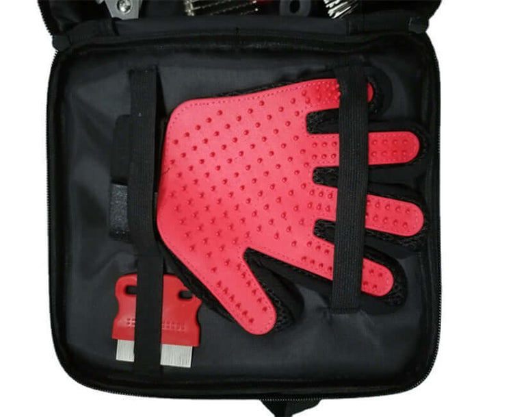 Portable pet cleaning kit containing a red grooming glove and cleaning tools in a black storage bag.