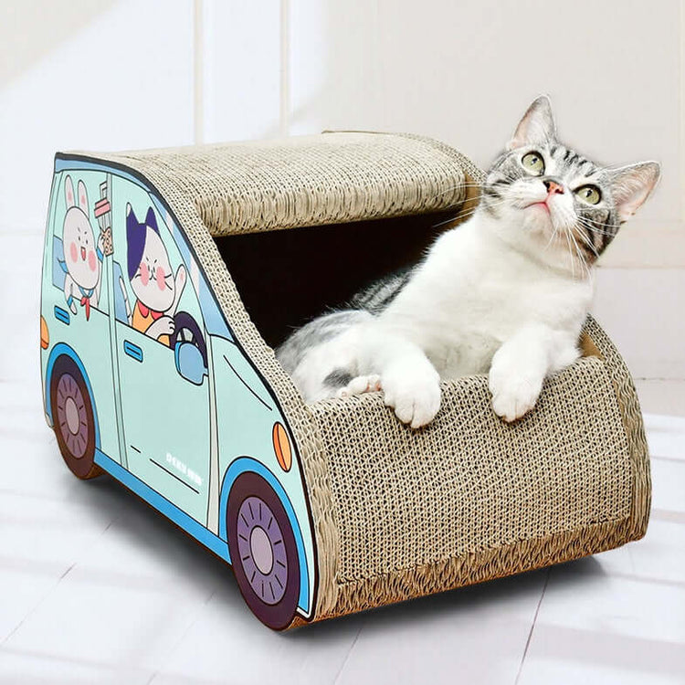 A cat lounging in an SUV car-shaped cat scratching board, featuring colorful cartoon characters.