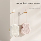 Soporte con cordón para secar y guardar guantes de aseo para mascotas, en blanco y rosa.