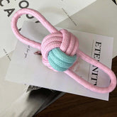 Interactive pet chew toy for dogs and cats in pink and blue cotton rope, designed for play and training.