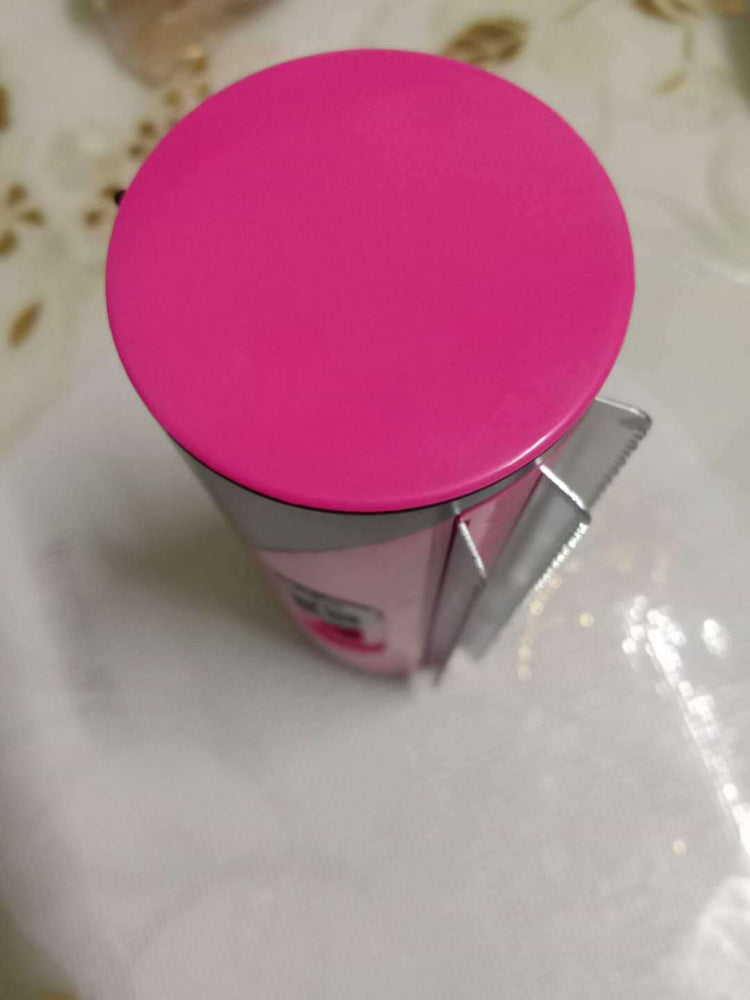 Close-up of a pet grooming brush for dogs and cats, featuring a pink cap and stainless steel design.