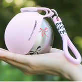 2-in-1 portable dog water bottle for small dogs held in a hand, featuring a pink silicone exterior and stainless steel interior.