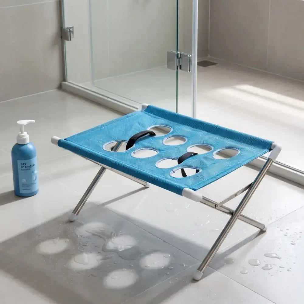 Foldable pet grooming table with quick-dry mesh, ideal for medium pets, featured in a bathroom setting.