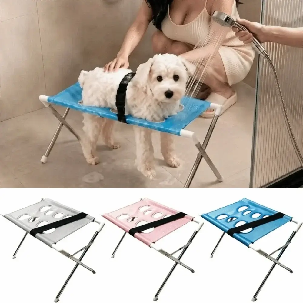 Foldable pet grooming table being used for dog washing with quick-dry mesh in a bathroom setting