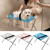 Foldable pet grooming table being used for dog washing with quick-dry mesh in a bathroom setting