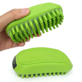Hand holding a green pet bath brush, part of the dog grooming and cleaning tools collection.