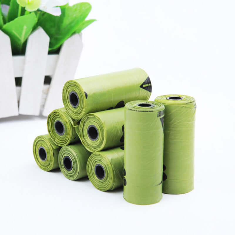 Hygienic dog poop bags in green rolls, perfect for pet waste disposal.