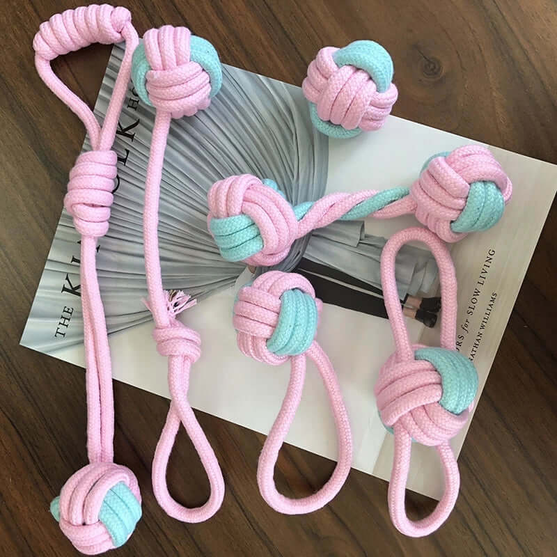 Interactive pet chew toy for dogs and cats in blue and pink cotton rope, 6-piece knot set.