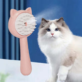 Steam cleaning grooming brush for cats shown next to a fluffy cat, highlighting its design and functionality.