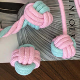 Interactive pet chew toy for dogs and cats, featuring colorful cotton rope knotted design.