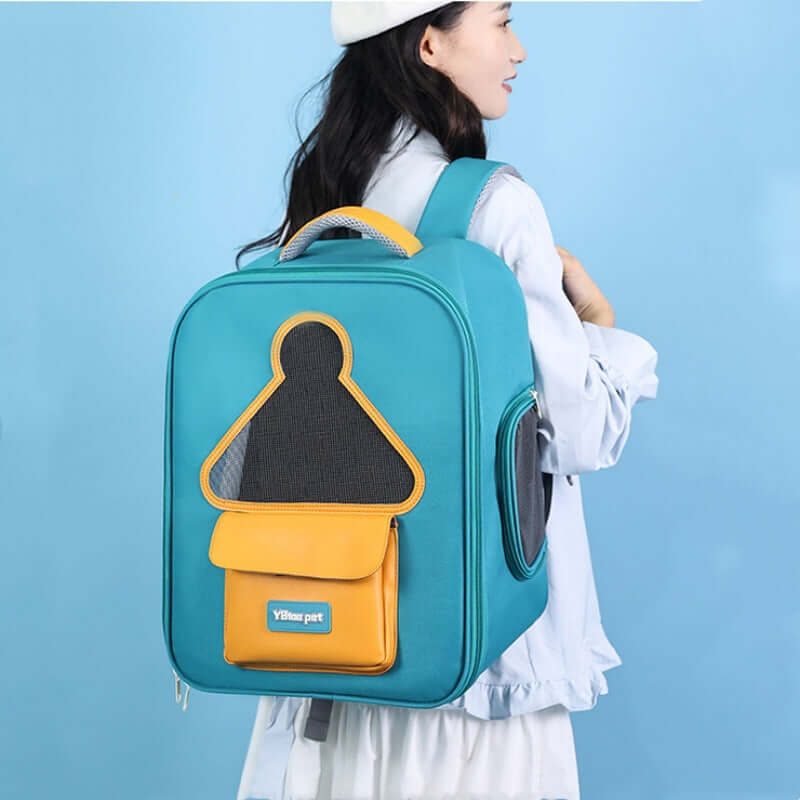 Cat carrier travel backpack in teal and yellow, perfect for pet travel.